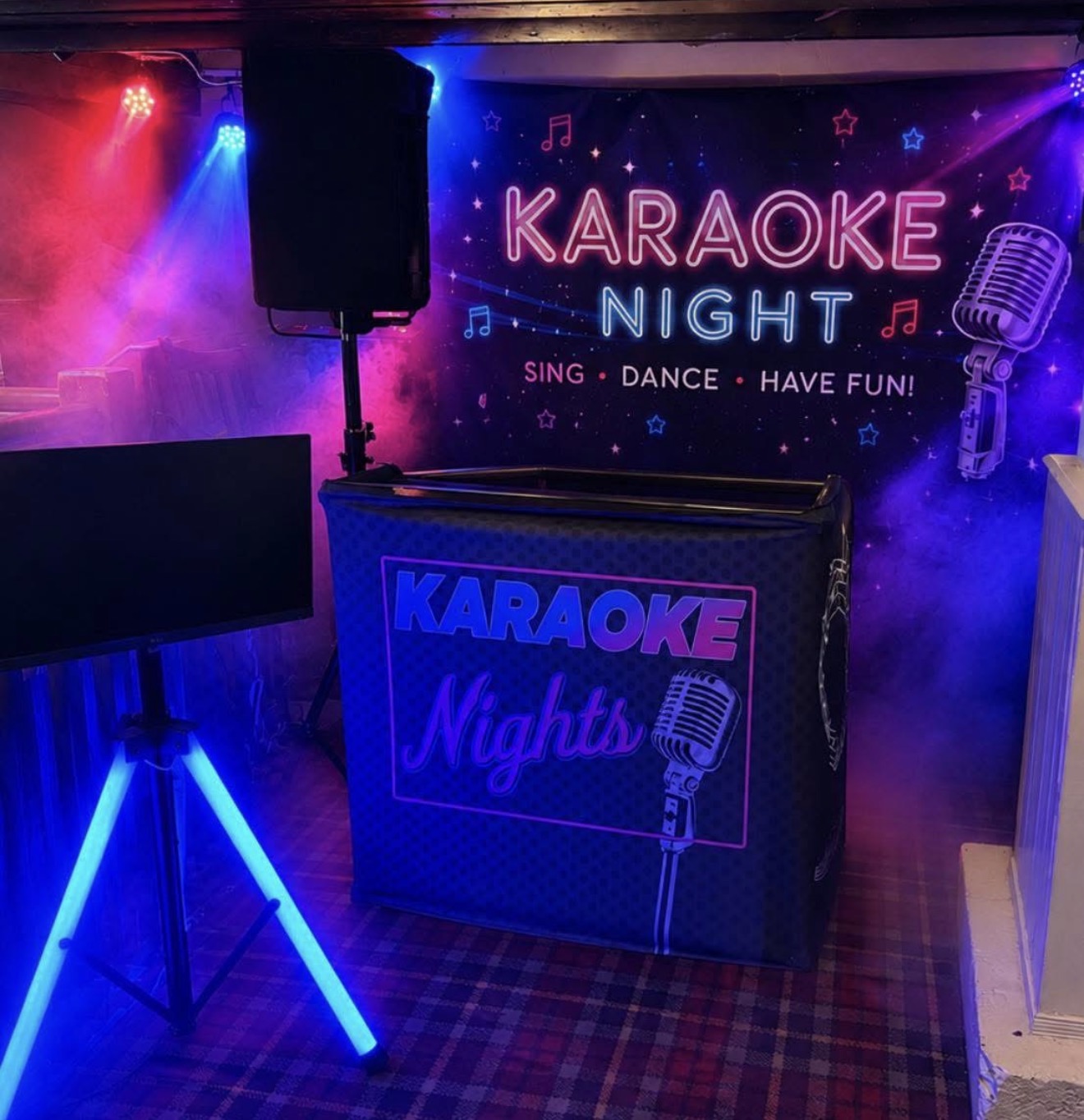 Essential Karaoke Disco setup with colourful lighting, karaoke booth, screen and backdrop