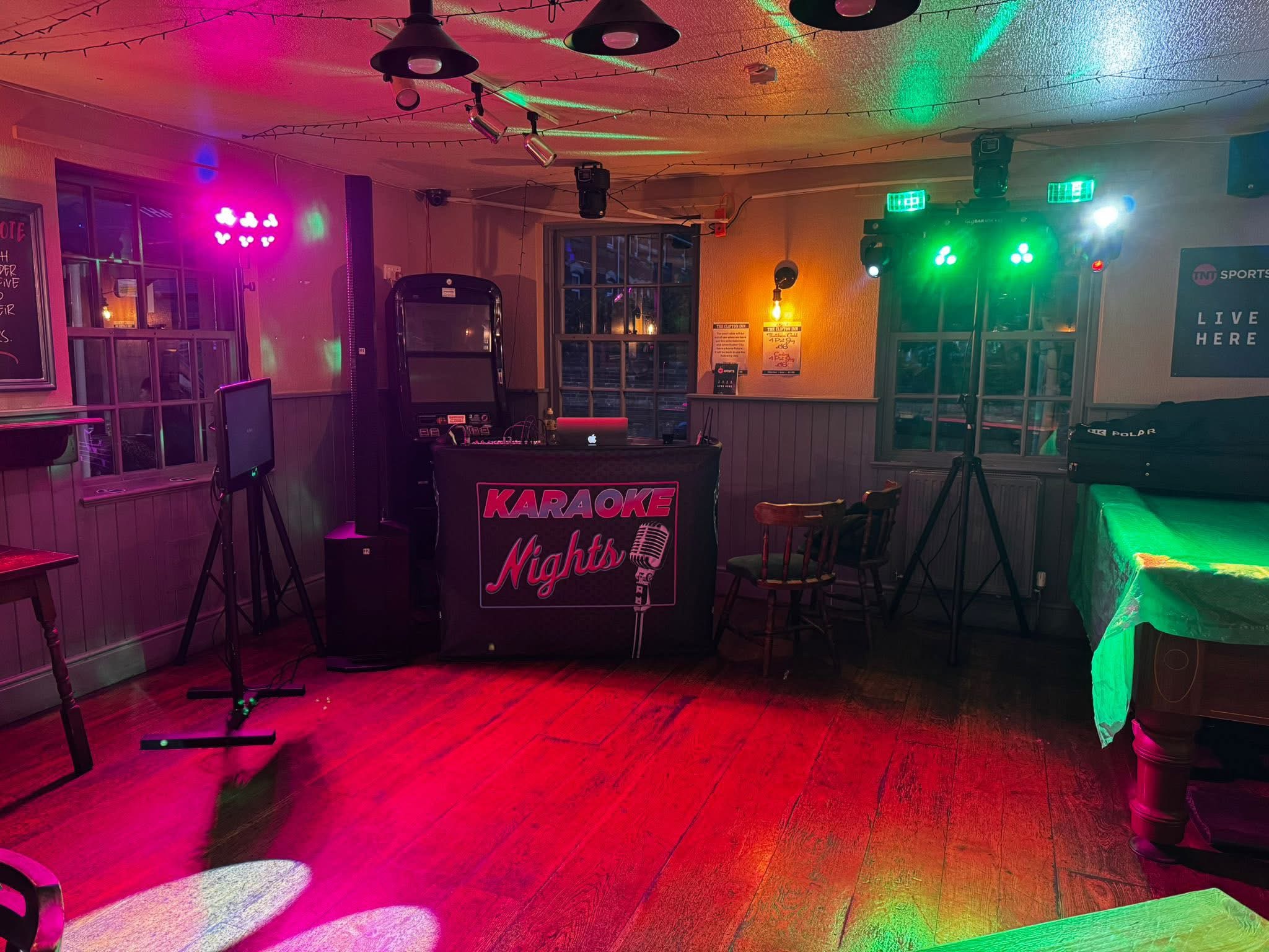 Karaoke booth, microphones and coloured lighting at a pub.