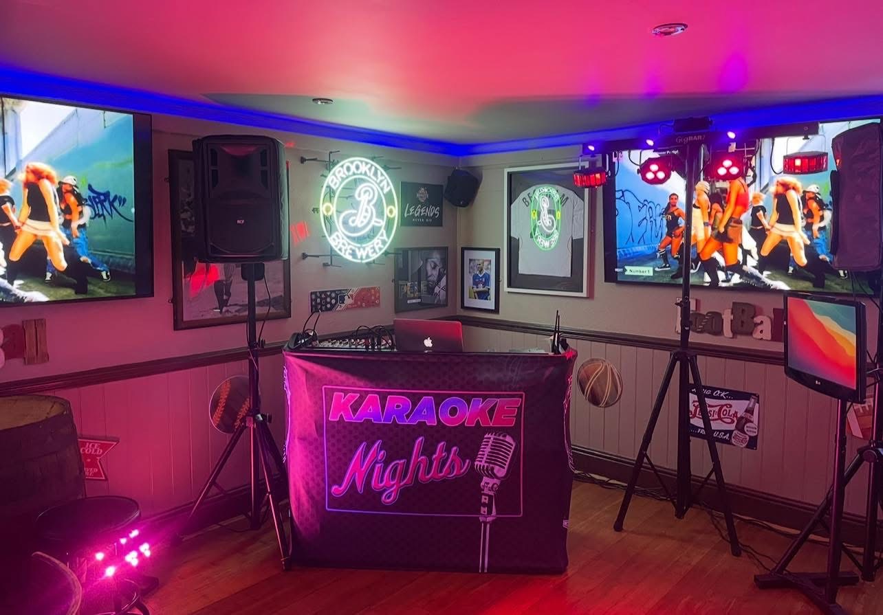 Essential Karaoke Disco setup with screens, speakers and pink lighting.
